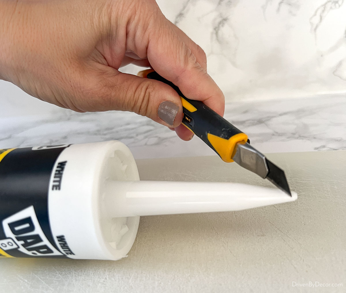 Cutting off tip of caulk tube