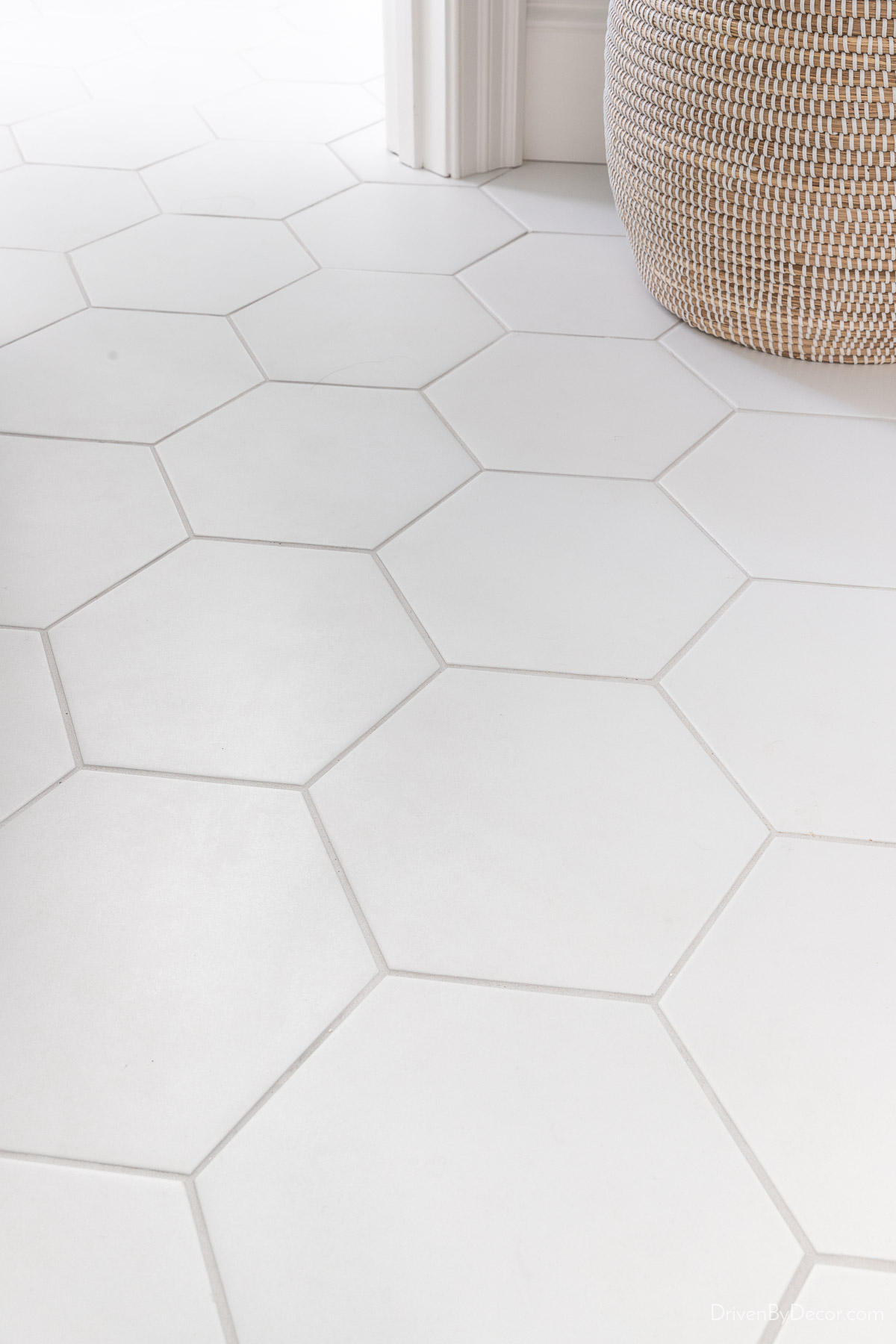 Large white hexagon tile on bathroom floor