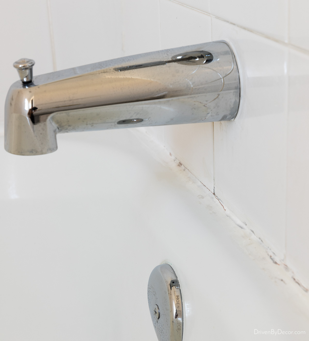 Old cracked caulk around bathtub