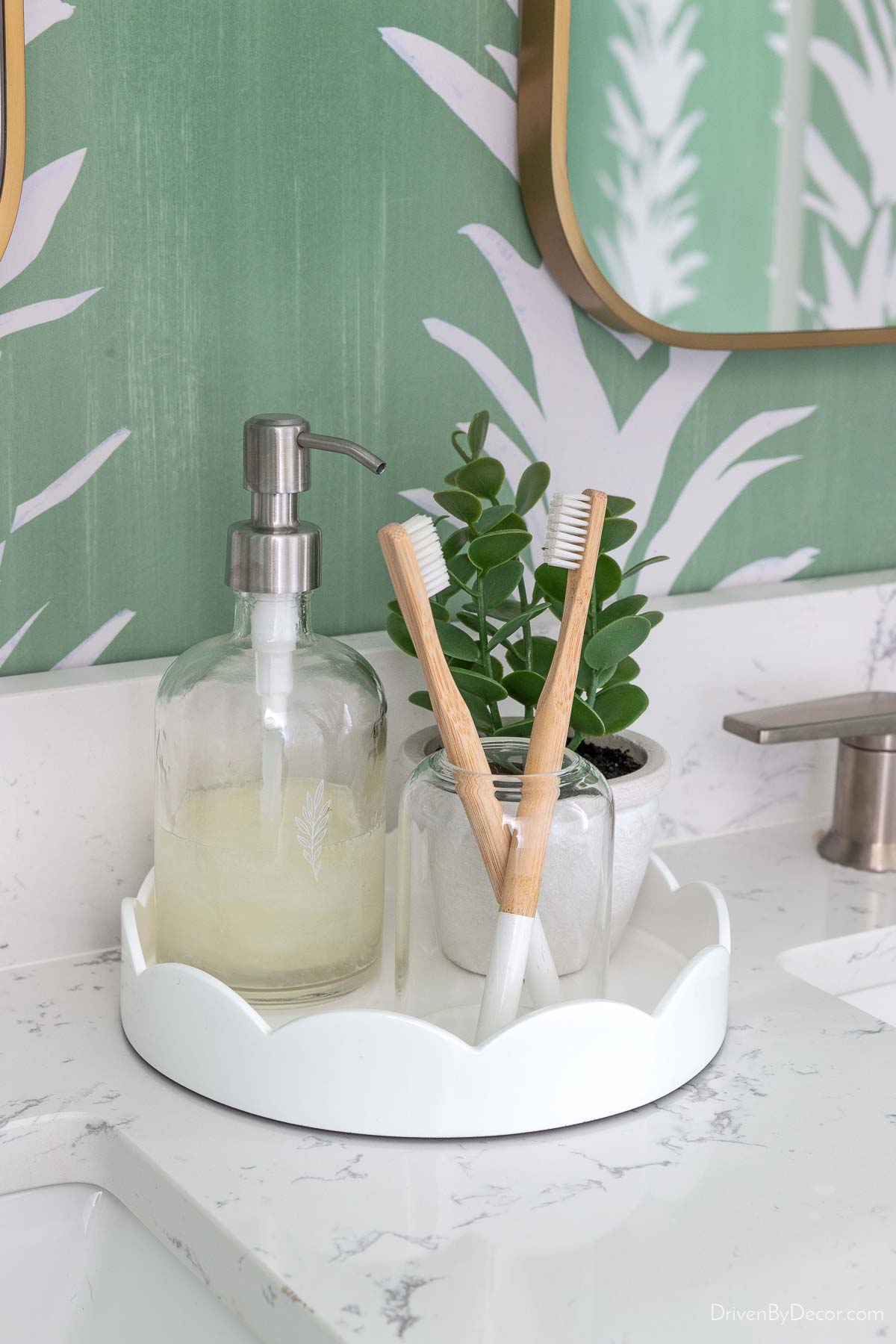 Round scalloped tray between sinks on double bathroom vanity