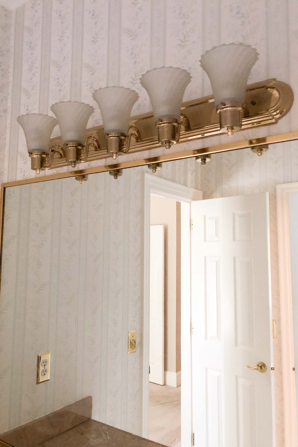 Bathroom mirror and lights before the remodel