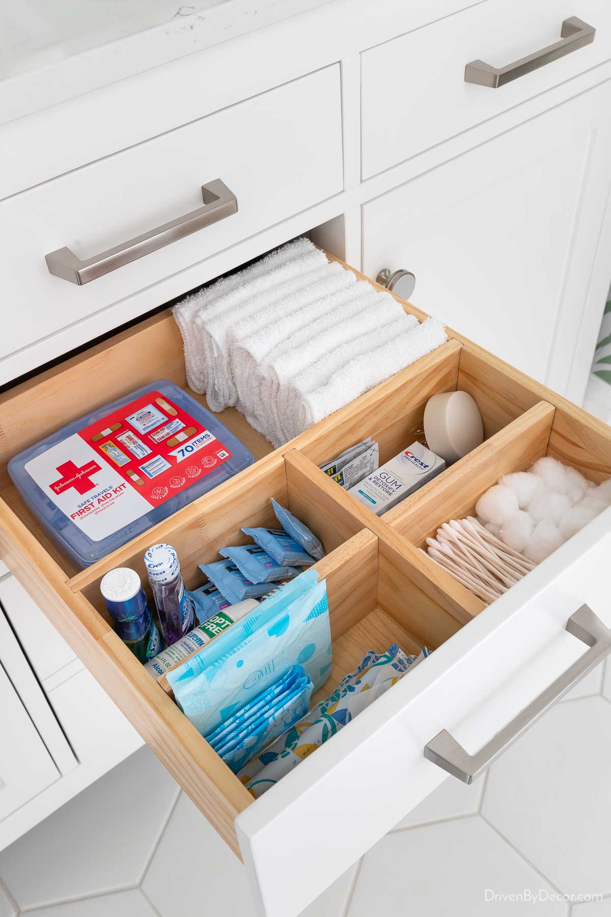 Wood dividers holding bathroom essentials in bathroom vanity drawer