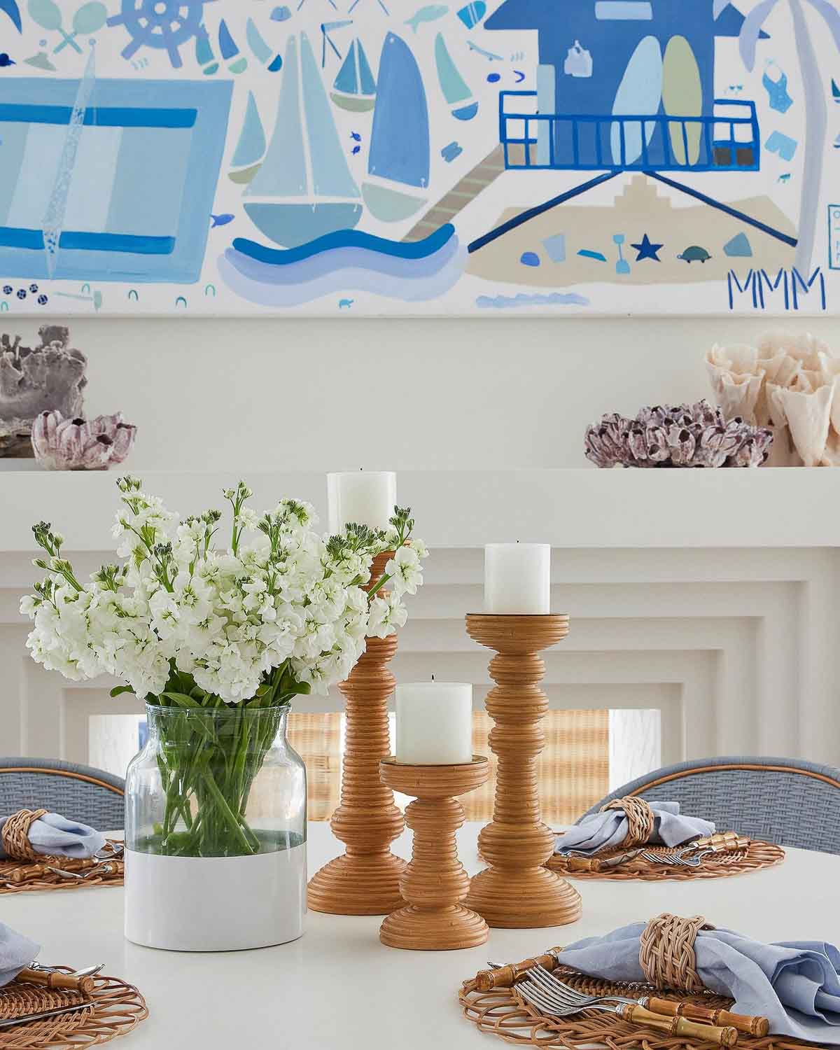 Centerpiece of rattan candlesticks and a vase of flowers