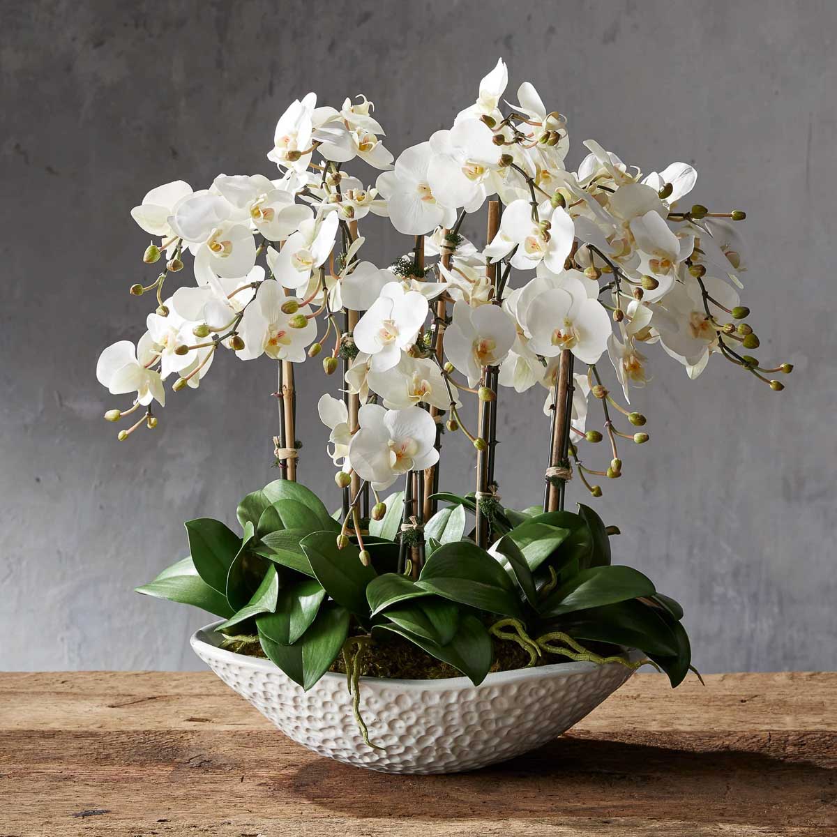 Faux orchids in large bowl