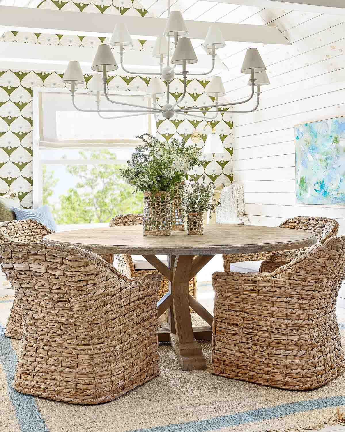 Three vases of flowers in varying heights as dining table centerpiece