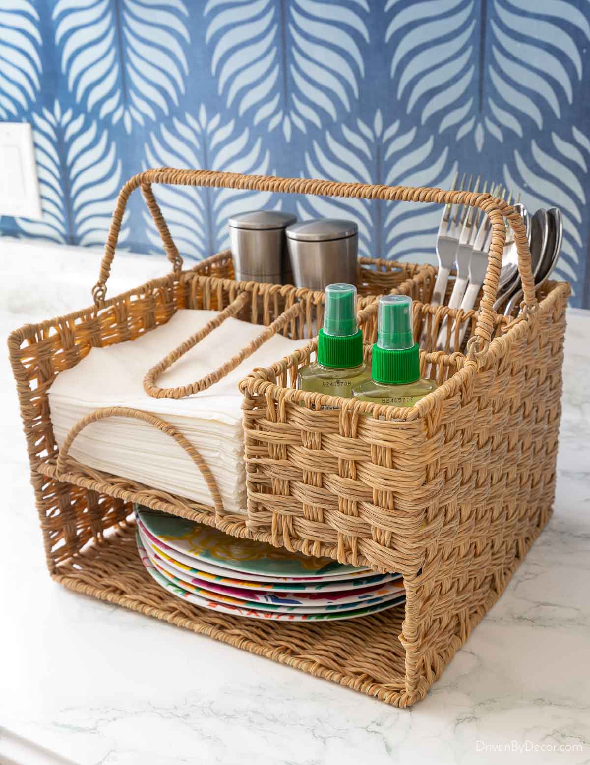 Woven serving caddy with plates, napkins, silverware, salt & pepper, and more