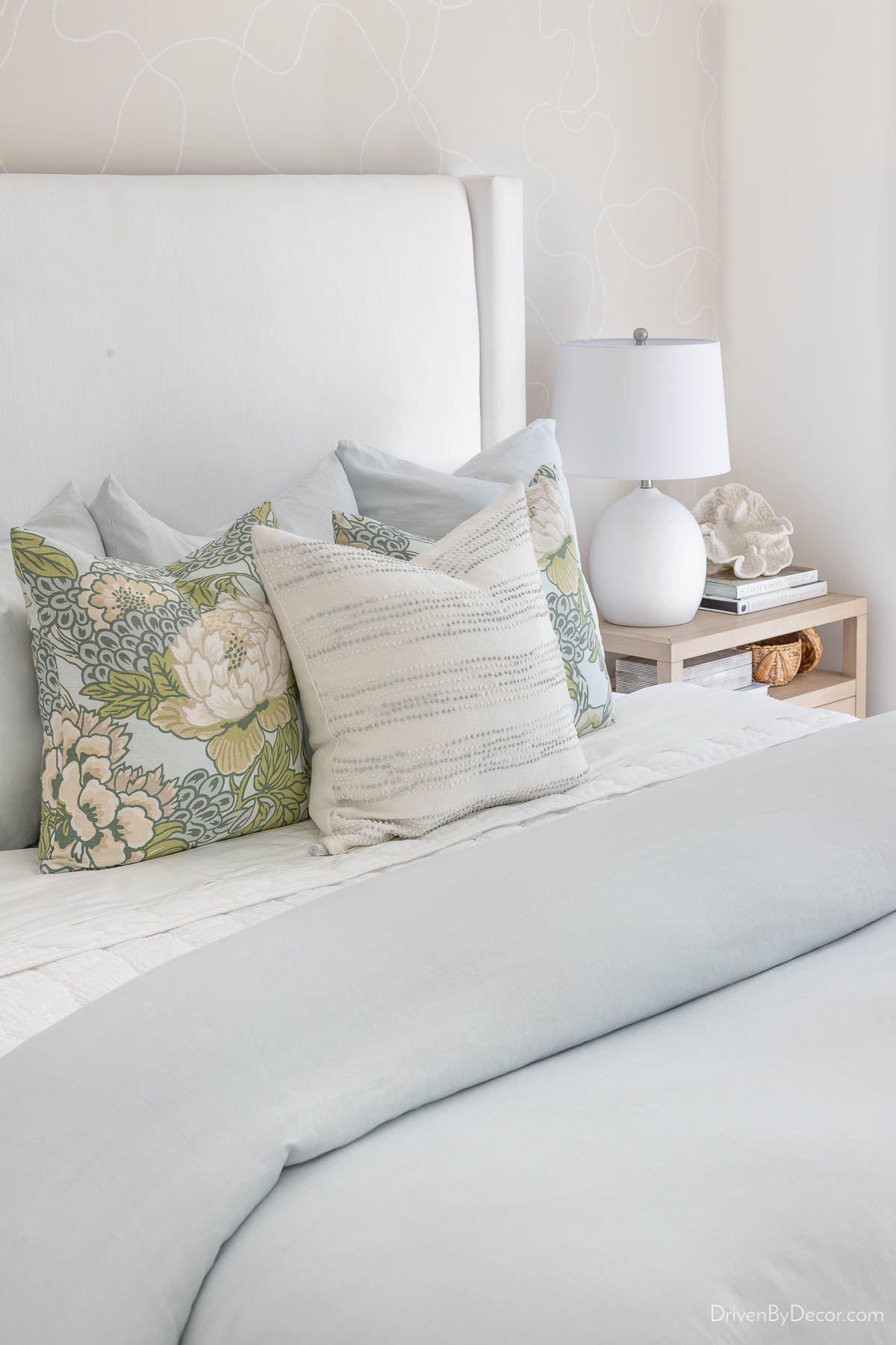 Decorative pillows in light blue bedroom