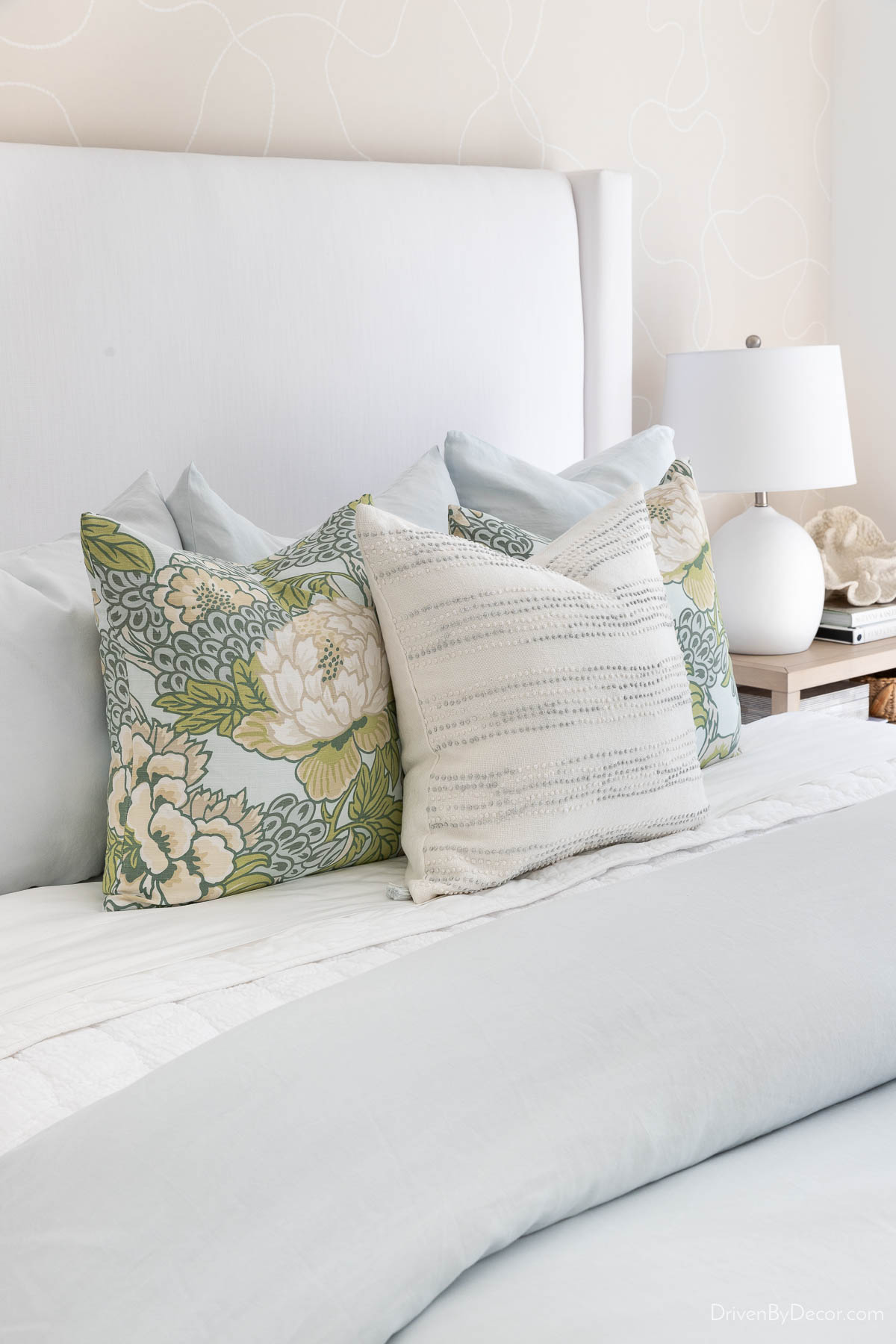 Decorative pillows in light blue bedroom