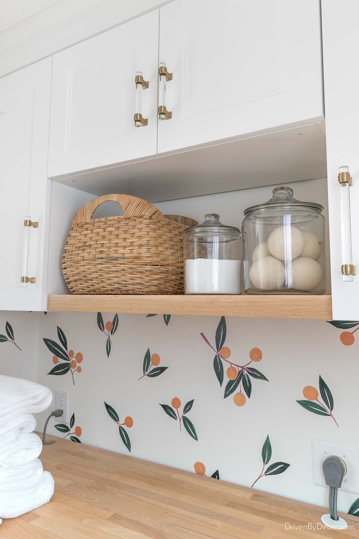 basket and glass jars on laundry room shelf