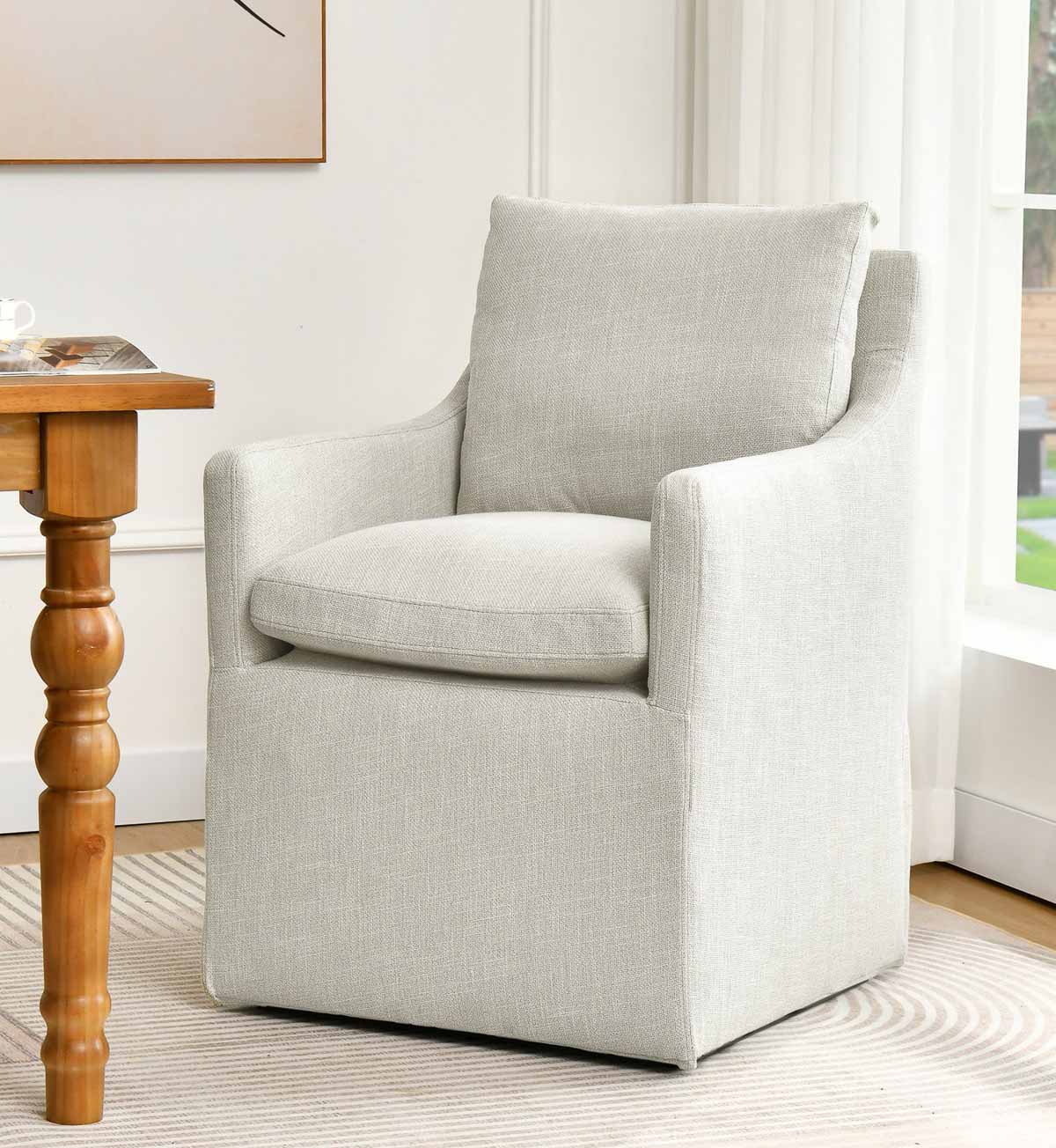 Upholstered dining armchair on casters