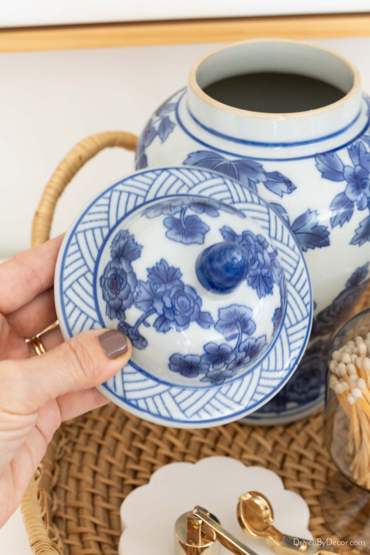 Favorite nail polish on hand holding lid to chinoserie jar