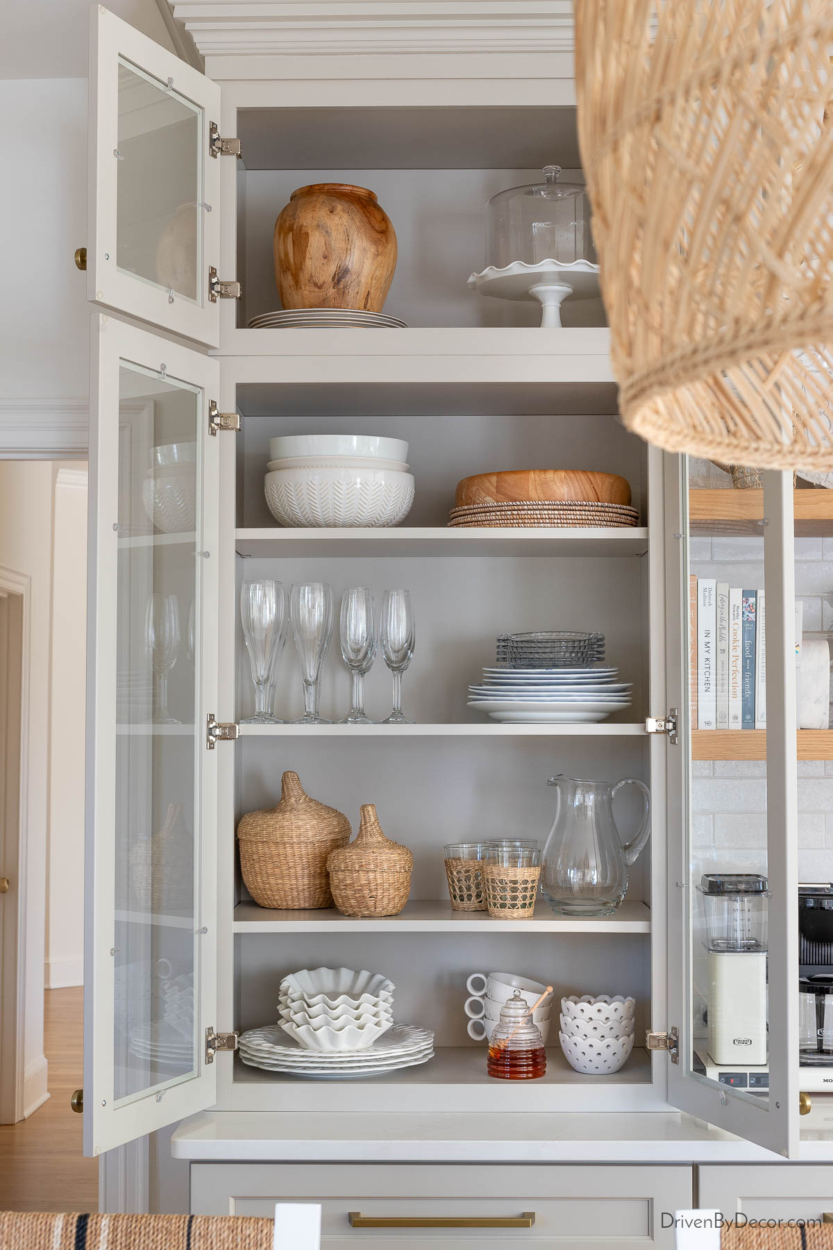 The upper glass cabinets of our kitchen coffee bar