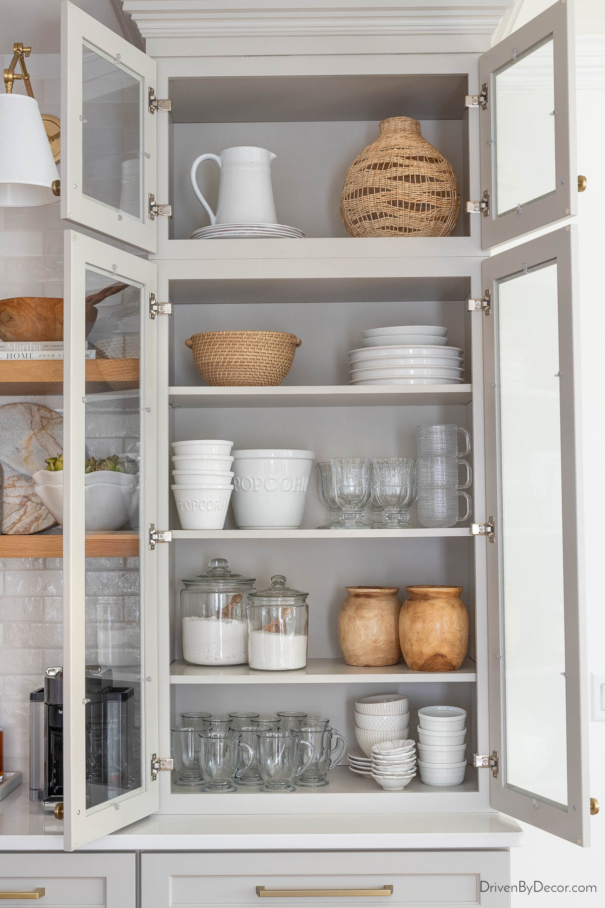 Storing dinnerware and serving pieces in our glass upper cabinets