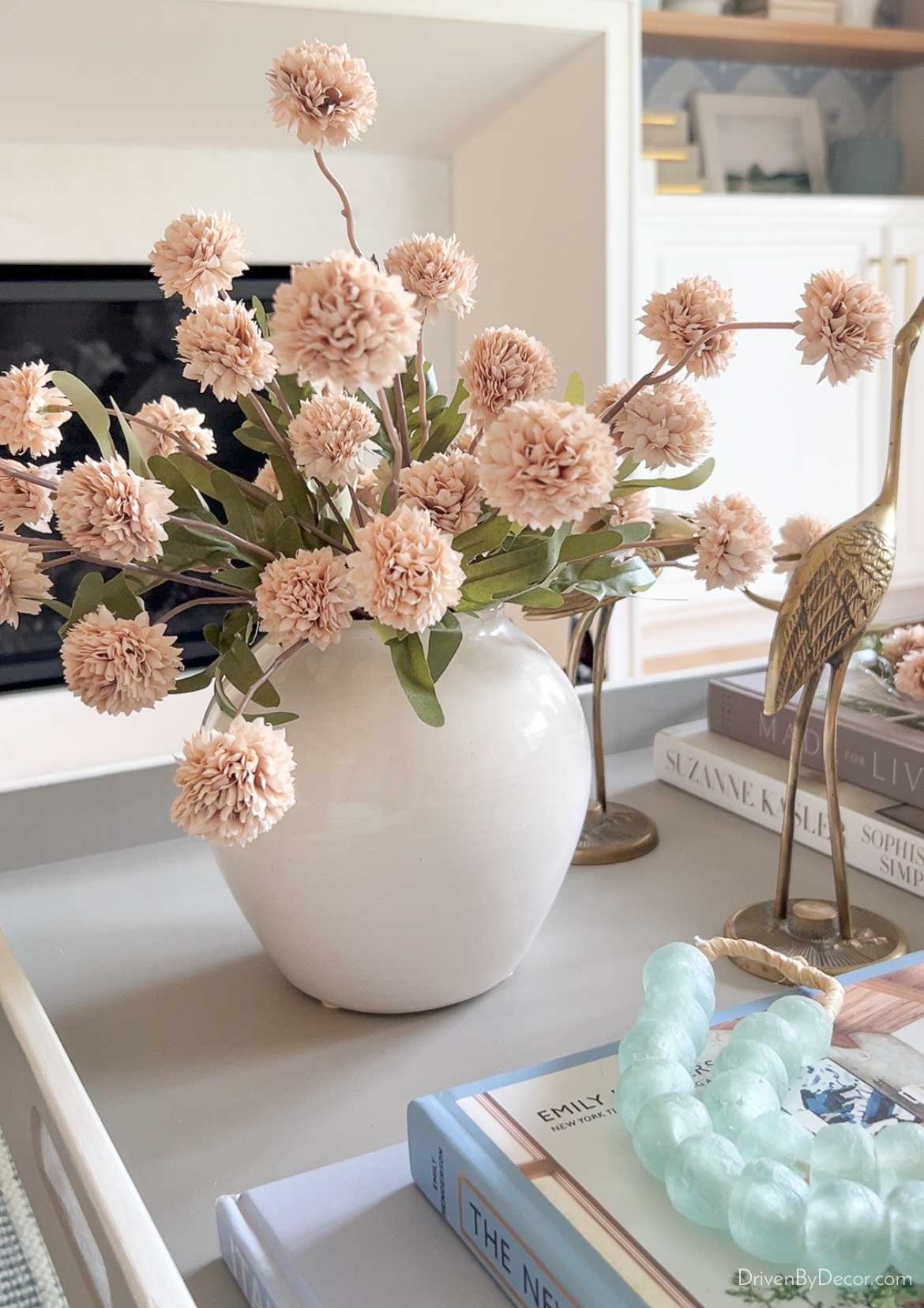Fall flowers in white vase on round coffee table