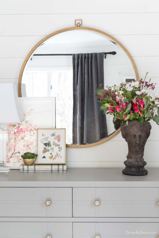 Large round mirror over dresser