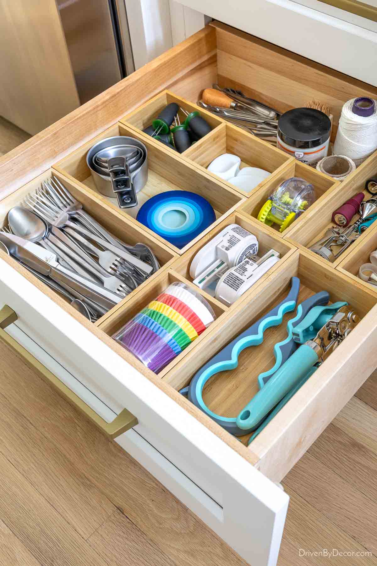 Bamboo kitchen drawer organizers filled with kitchen tools