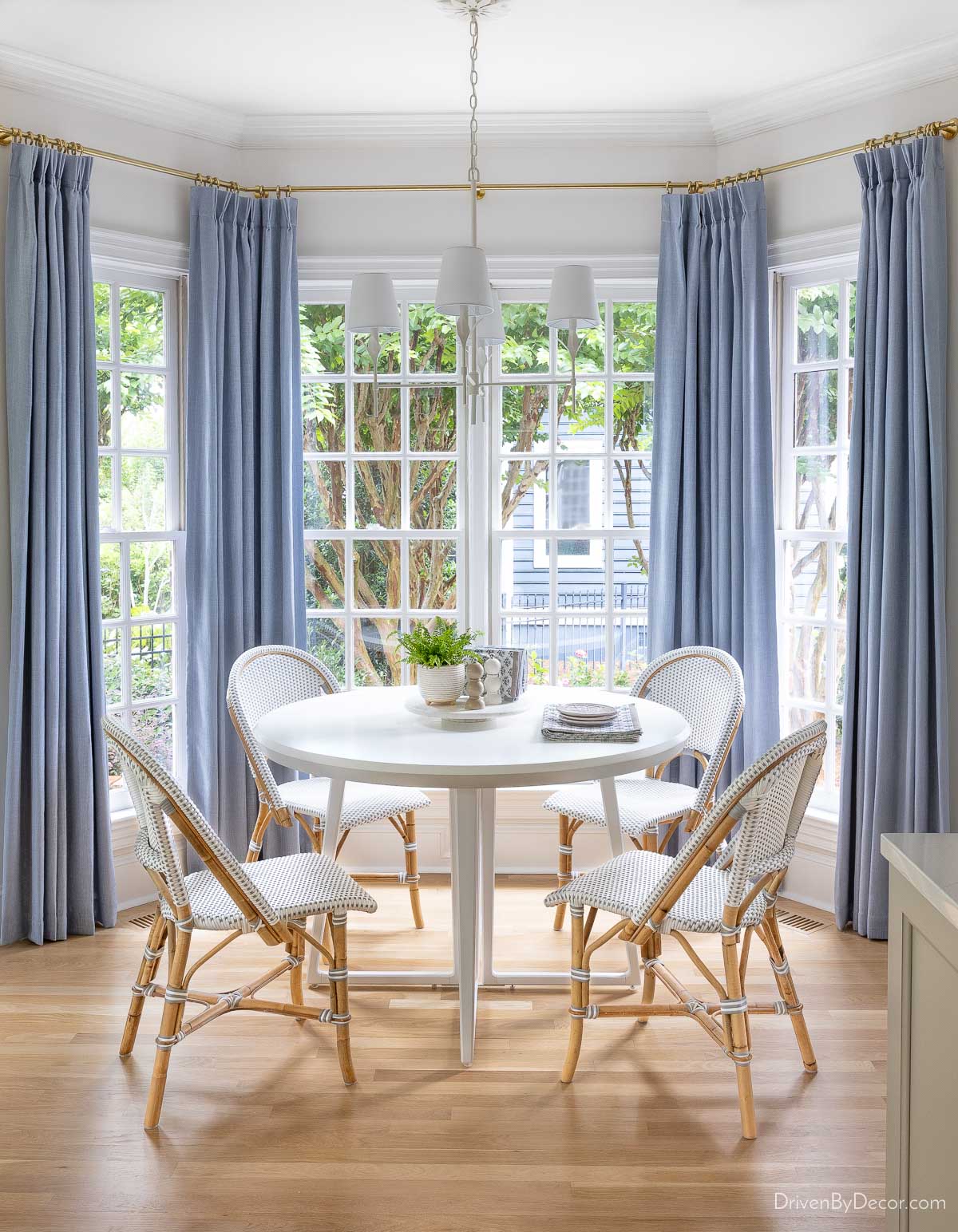Bay window breakfast nook with light blue curtains