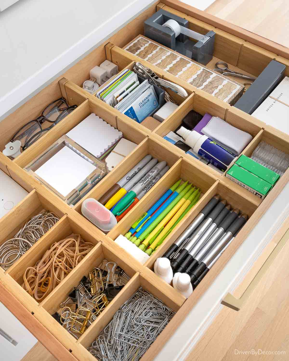Bamboo organizer with adjustable dividers holding desk supplies