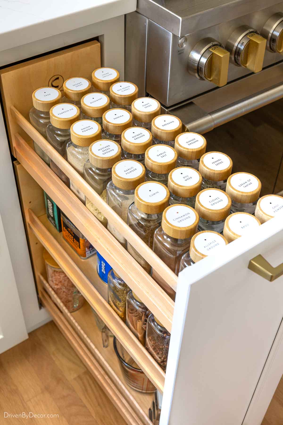 Labeled spice jars in kitchen pullout spice rack