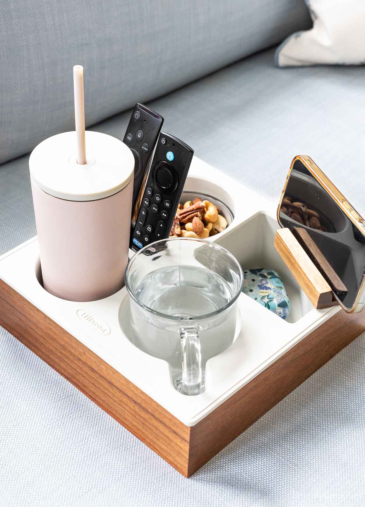 Couch caddy with compartments for drinks, snacks, remotes, and more