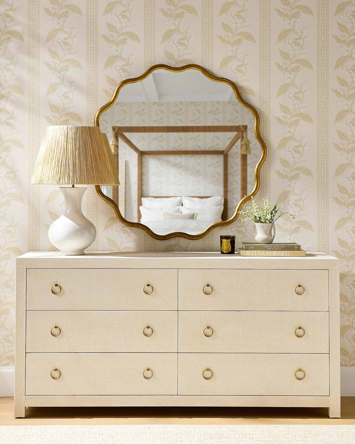 Linen wrapped dresser with lamp and scalloped mirror