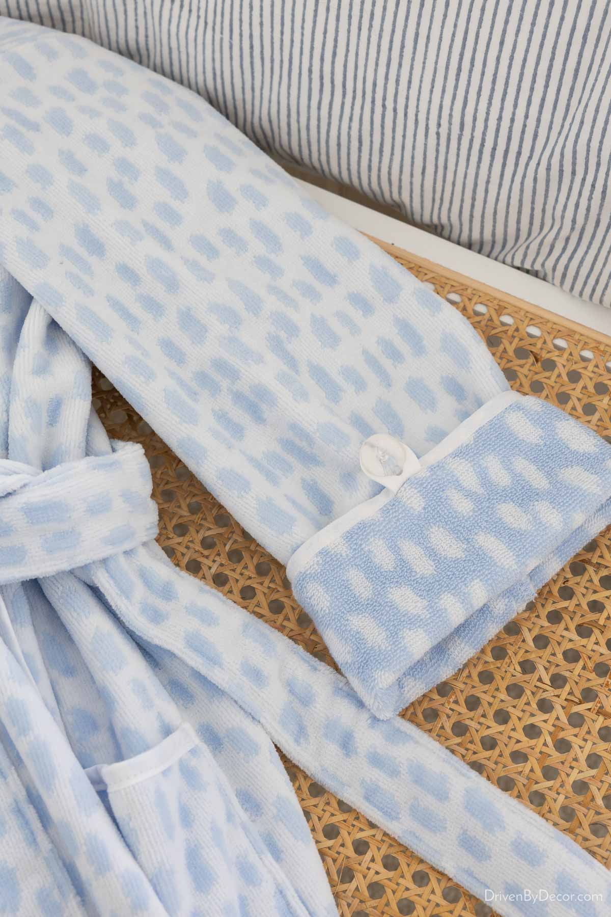 Sleeve of plush robe showing button that keeps rolled up sleeves in place