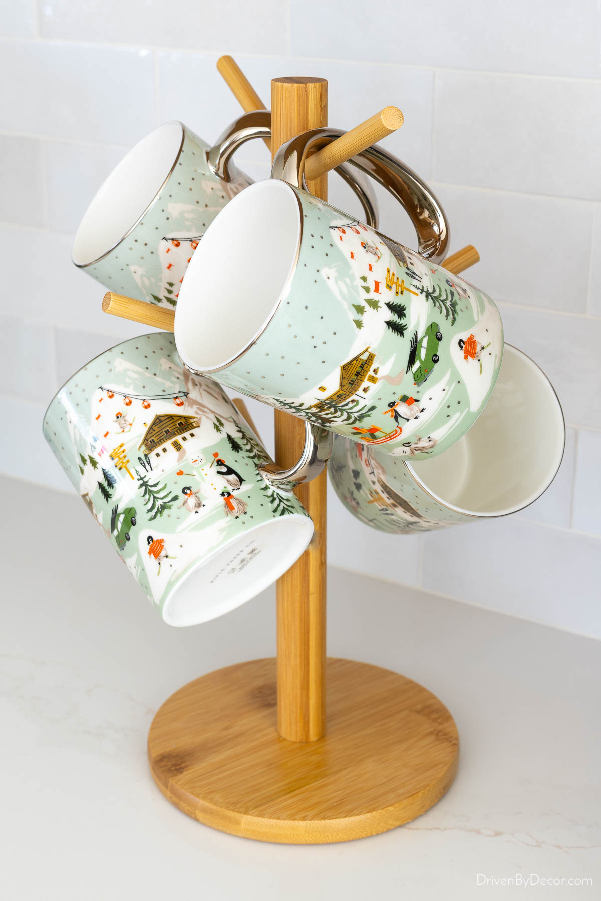 Mug tree holding Christmas themed mugs