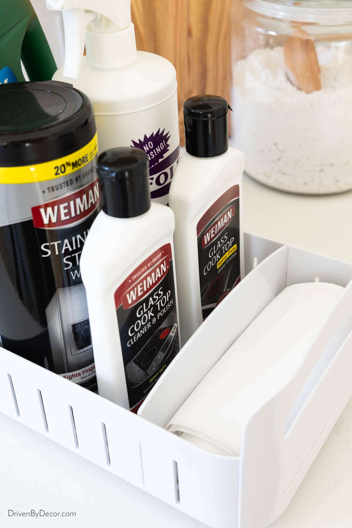 Adjustable dividers in rolling organizer holding cleaning supplies