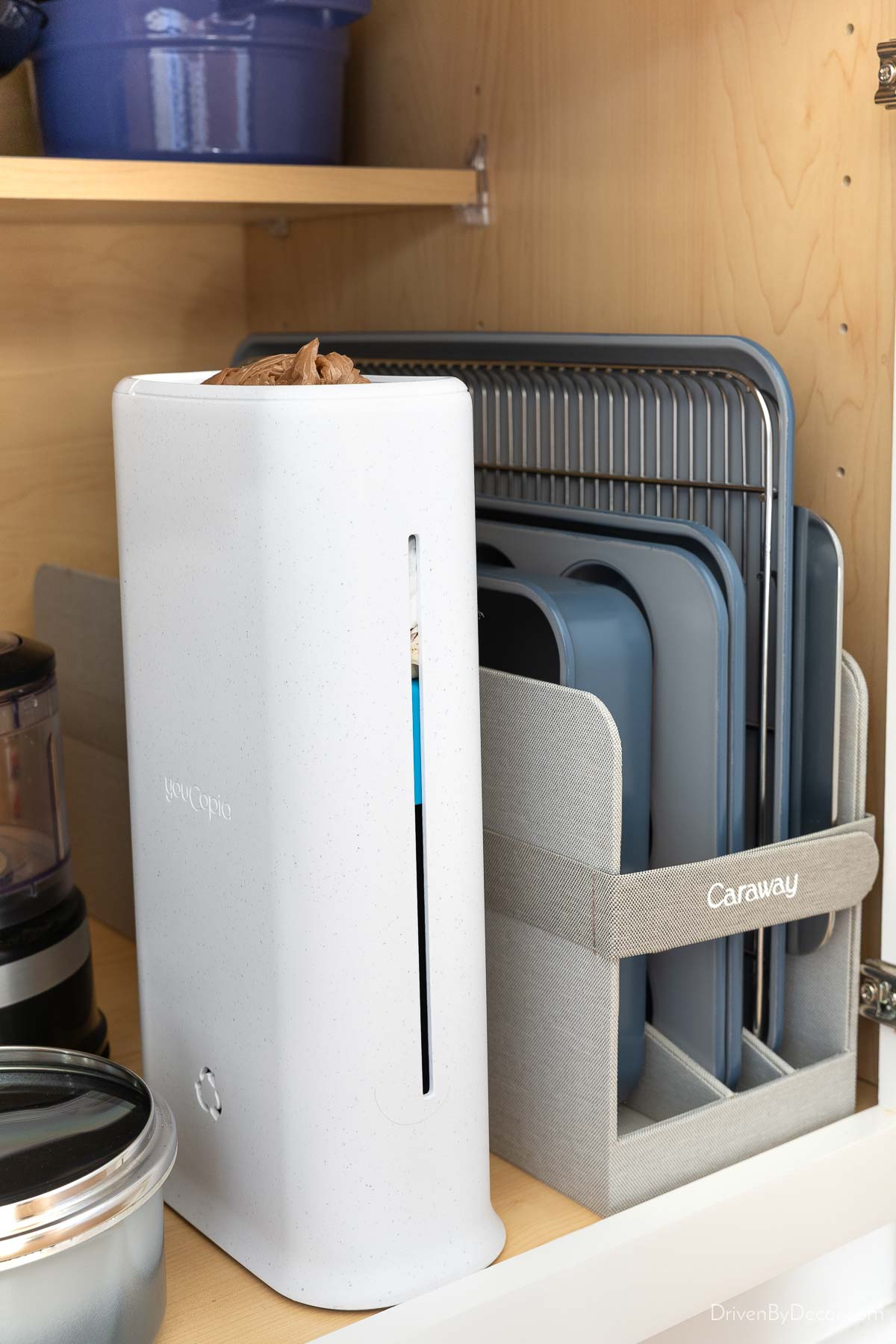 White plastic bag dispenser inside cabinet for kitchen organization