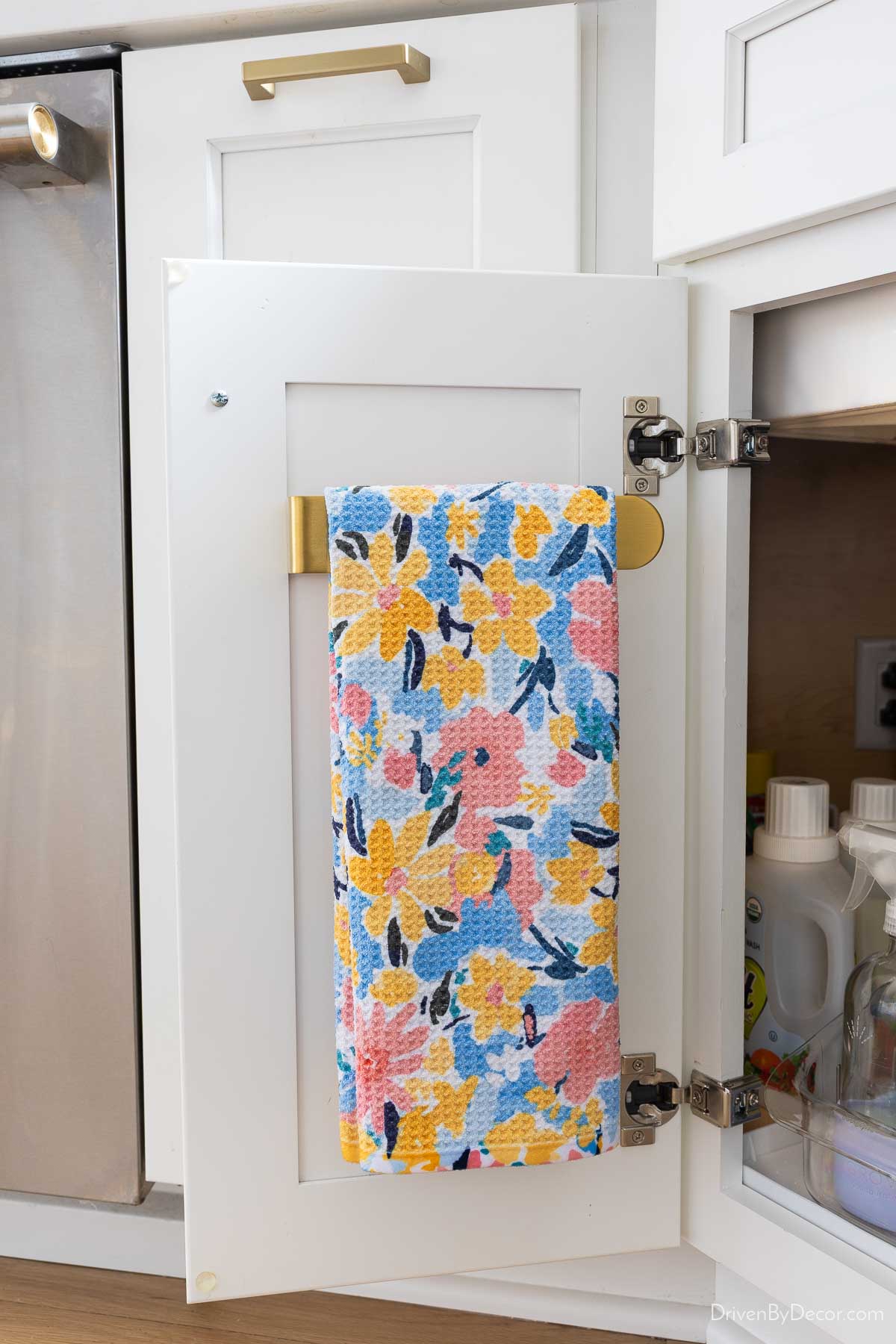 Dish towel hung on holder on inside of cabinet door