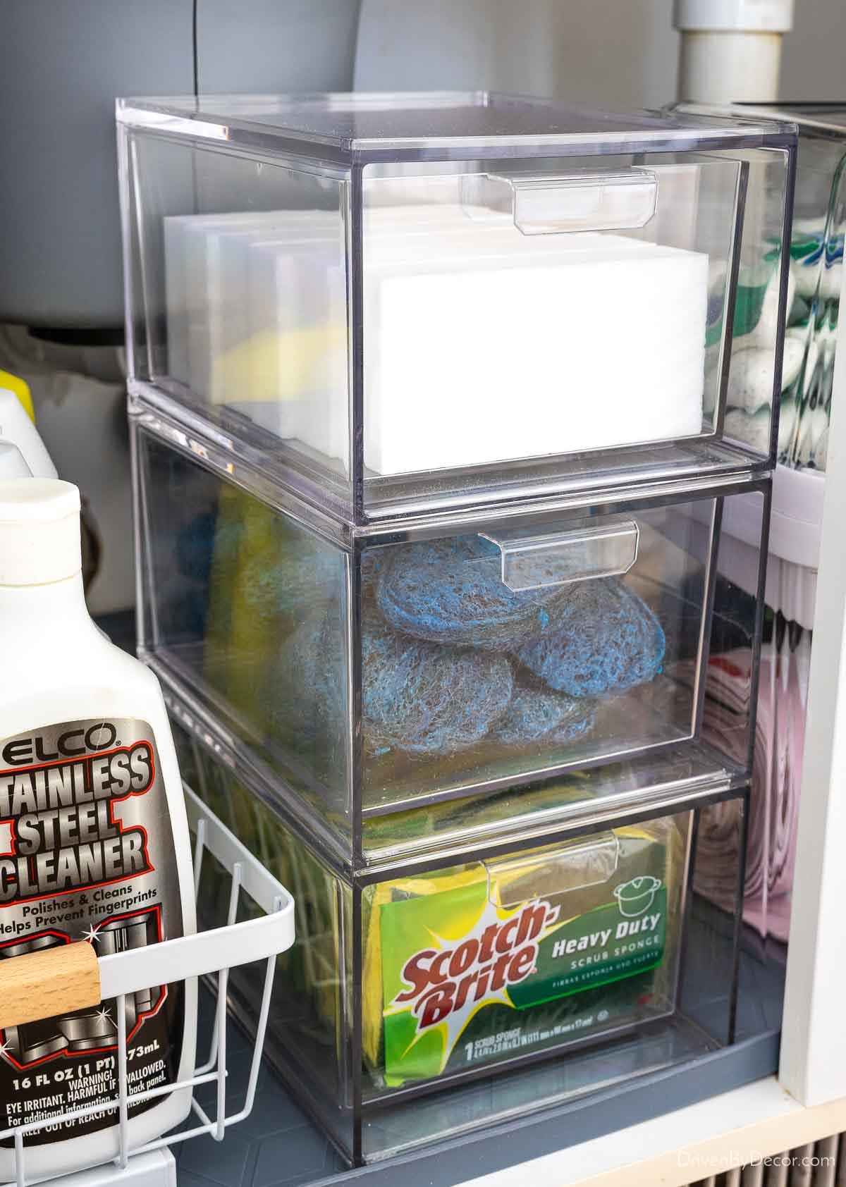 Stackable acrylic drawers holding sponges and cleaning pads under sink