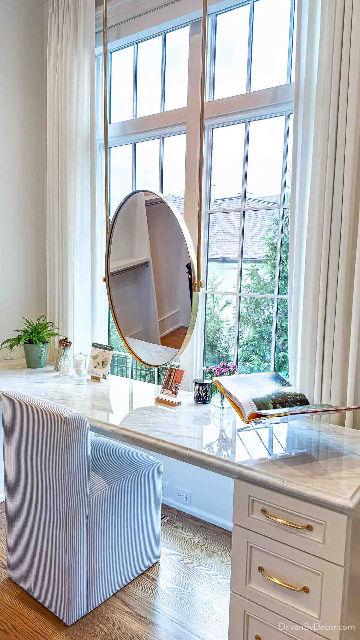 Sit down vanity with mirror in front of window in closet