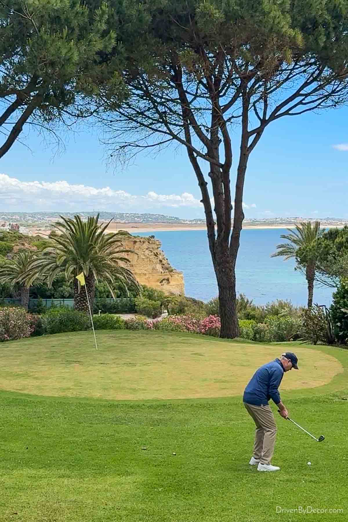Man playing golf in the Algarve with the ocean and cliffs in background