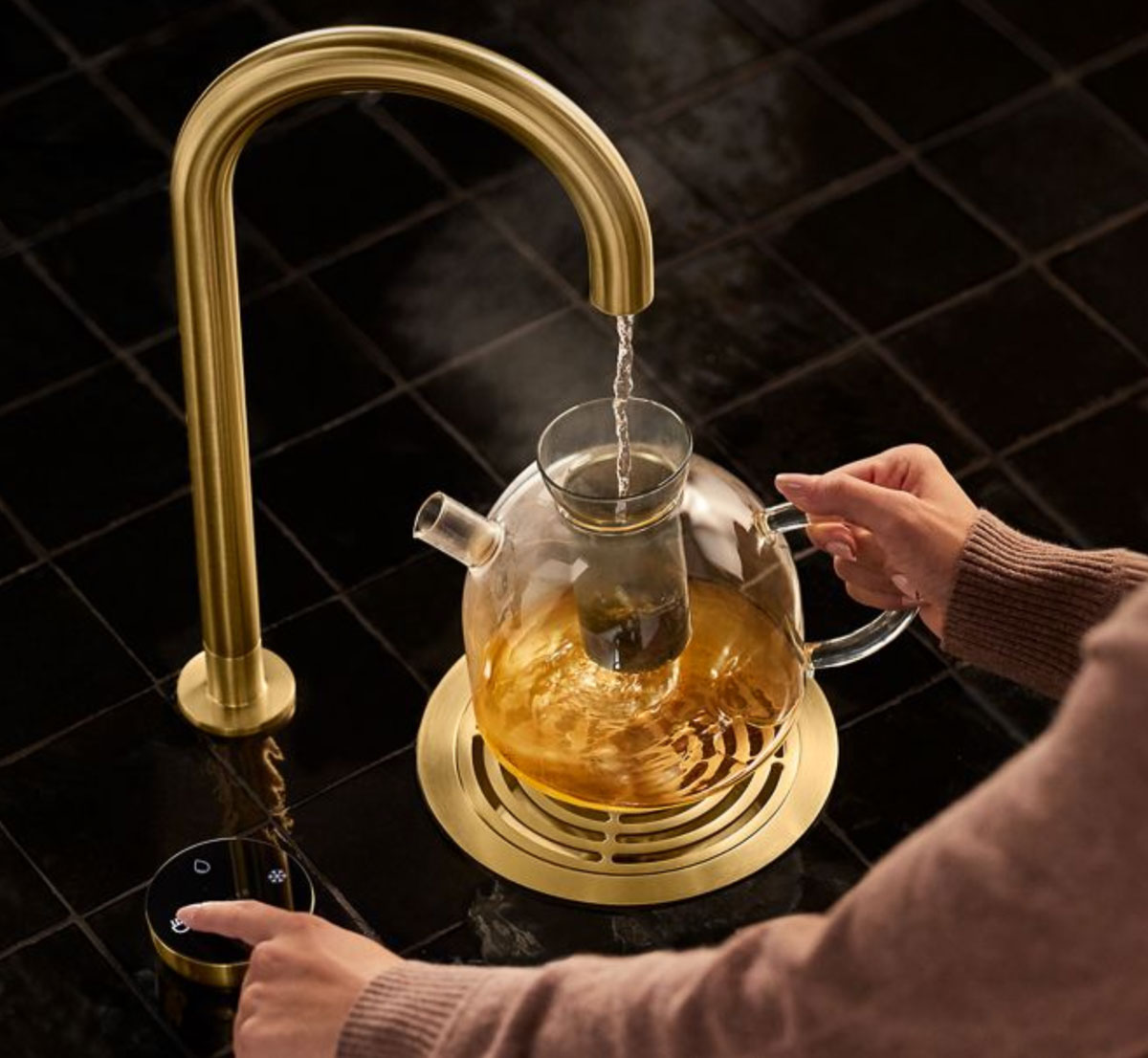 Kohler Aquifer filtration system dispensing hot water into a carafe