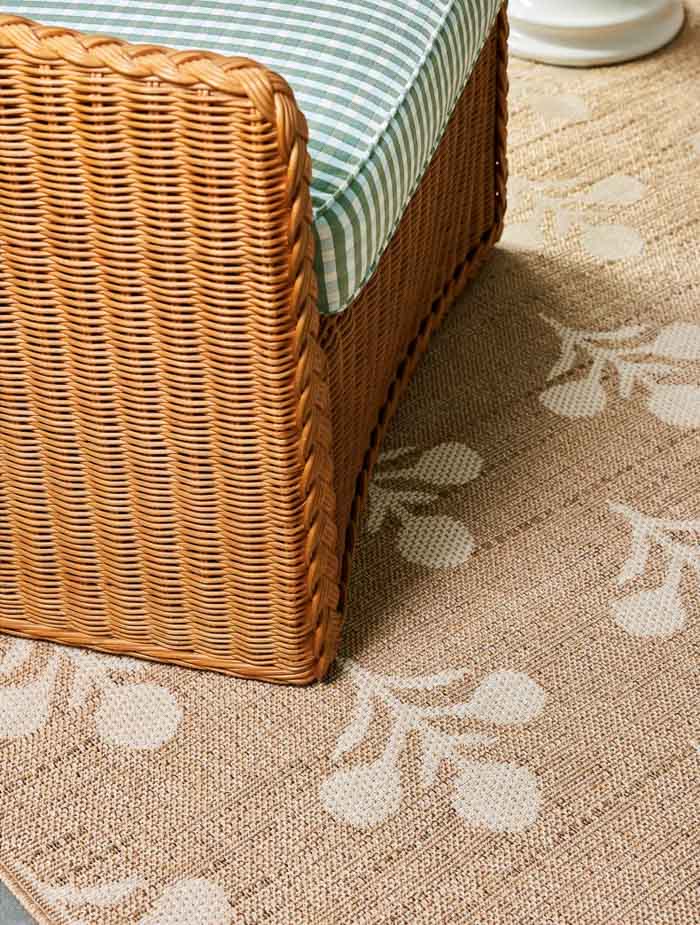 Floral patterned neutral rug with chair