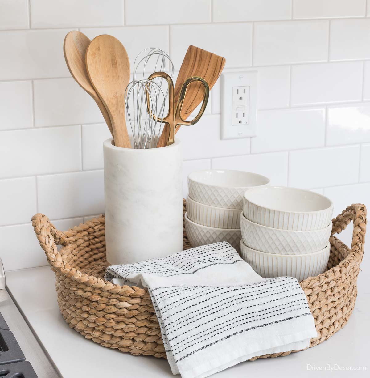 Marble wine cooler holding utensils next to kitchen range