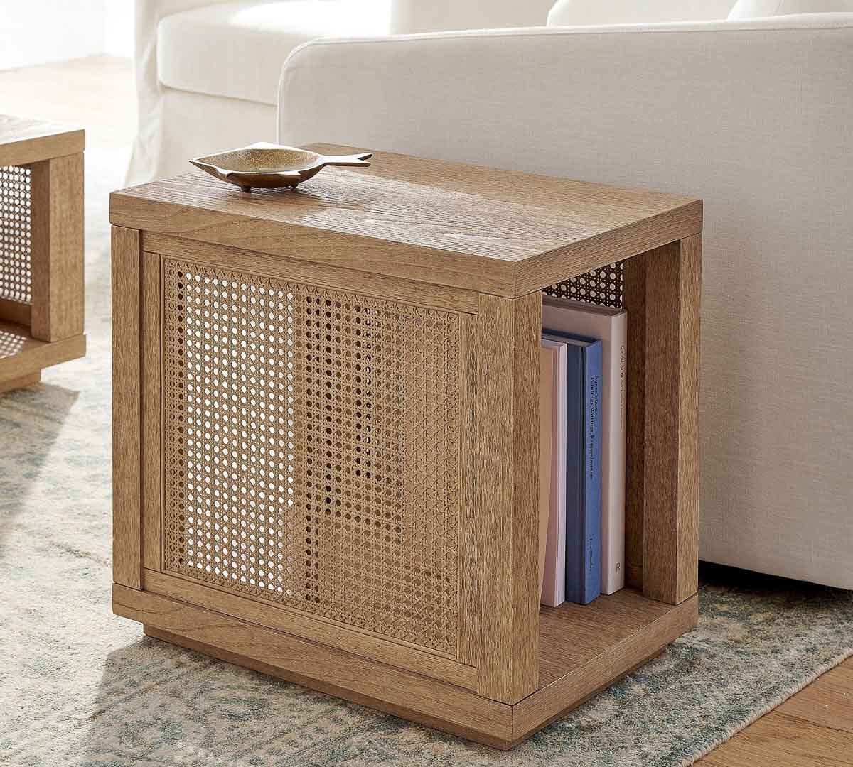 Cane side table with storage next to chair