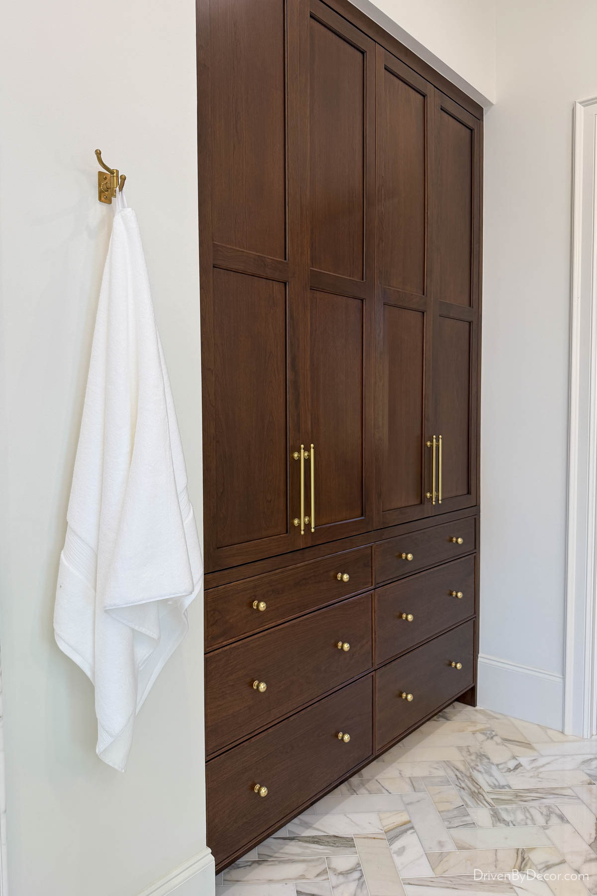 Dark wood storage cabinet in bathroom